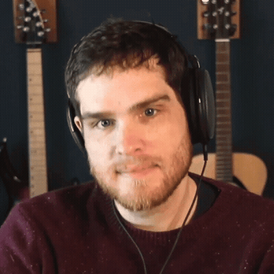 Bearded Man With Headphones Looking At Camera GIF
