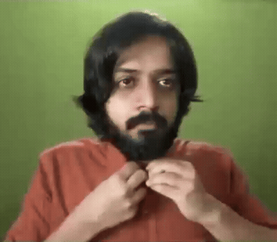 Bearded Man With Long Hair Adjusting Shirt GIF
