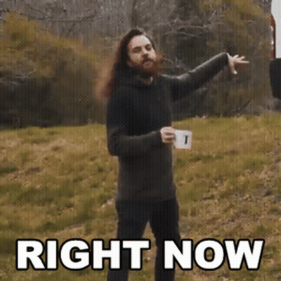 Bearded Man With Long Hair Holding Coffee And Pointing GIF