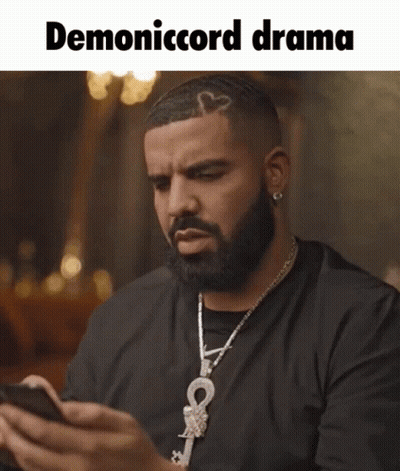 Bearded Man With Necklace Looking At Phone Demonicord Drama GIF