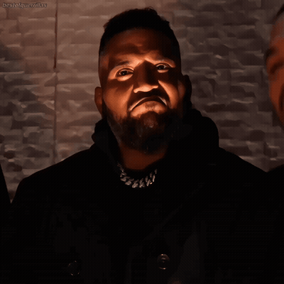 Bearded Man With Necklace Looking Up At Light GIF