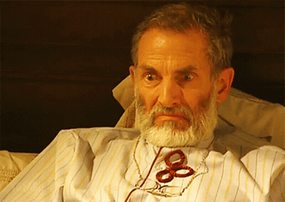 Bearded Man With Scissors Tied To Neck GIF