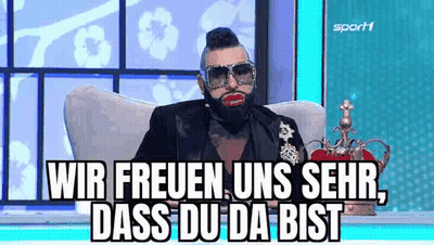 Bearded Man With Sunglasses And Crown Sitting On Chair GIF