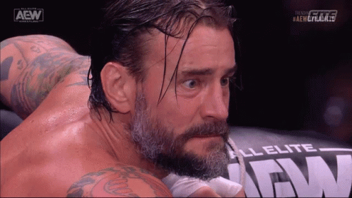 Bearded Man With Tattoos Laying On AEW Pillow GIF