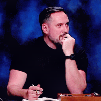 Bearded Man With Watch And Pen At Table GIF