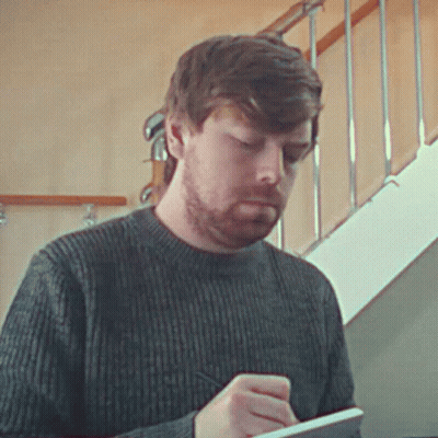 Bearded Man Writing On Notepad GIF