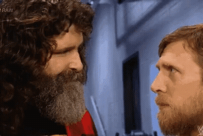 Bearded Men Stare At Each Other In Dark Room GIF