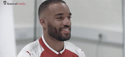 Bearded Soccer Player Smiling In Red And White Jersey GIF