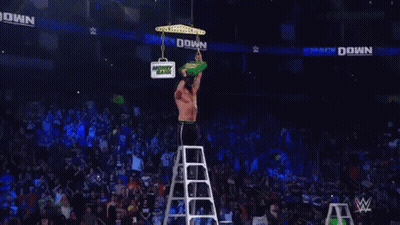 Bearded Wrestler Holding Green Money Bank GIF
