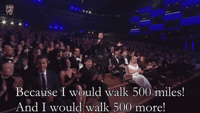 Because I Would Walk 500 Miles And I Would Walk 500 More Written In Front Of A Crowd GIF