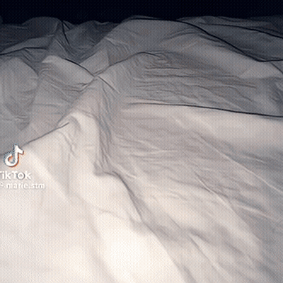 Bed With White Sheets And TikTok Watermark GIF