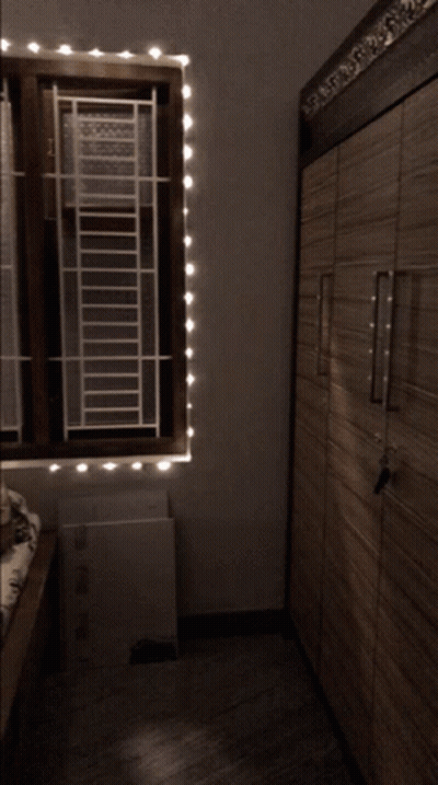 Bedroom With Bed And Window Blinds GIF