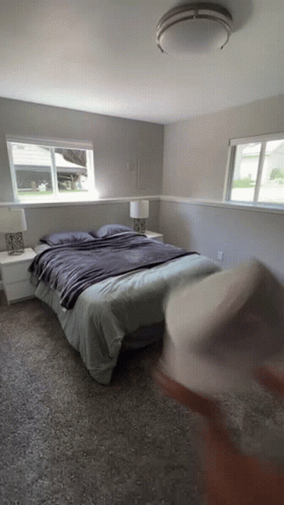 Bedroom With Bed Two Lamps And Window GIF