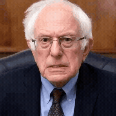 Bernie Sanders Is Wearing Glasses And A Suit And Tie And Making A Funny Face . GIF
