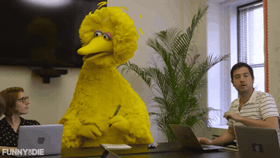 Big Bird From Sesame Street Sits At A Table With A Man And Woman GIF