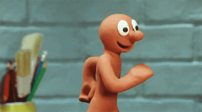 Big-Eyed Cartoon Character Running By Brick Wall GIF