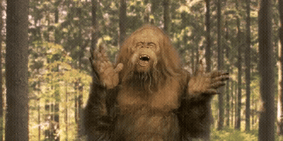 Bigfoot Standing In Forest With Mouth Open GIF