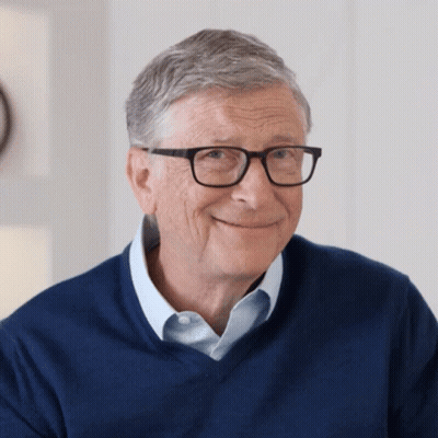 Bill Gates Smiling In Glasses And Blue Shirt GIF