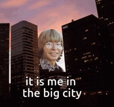 Billboard With Man In Glasses Saying It Is Me In The Big City GIF
