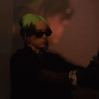 Billie Eilish Is Wearing Sunglasses And Gloves In A Pixelated Photo GIF