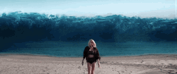 Billie Eilish Walking In Big Waves Background GIF