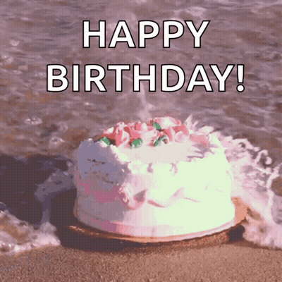 Birthday Cake On Beach Saying Happy Birthday GIF