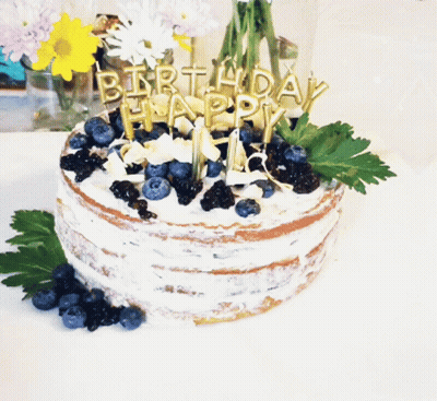 Birthday Cake With Blueberries And Candles Saying Happy GIF