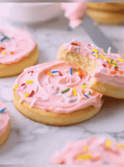 Bitten Cookie With Pink Frosting And Sprinkles GIF