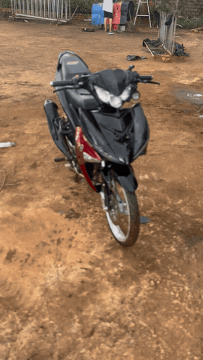 Black And Red Motorcycle Parked On Dirt Field GIF