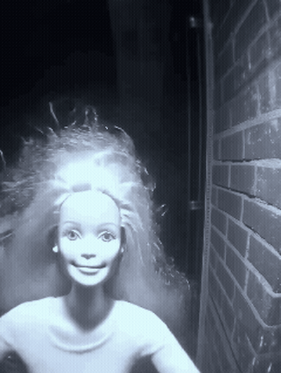 Black And White Barbie Doll With Brick Wall GIF