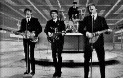 Black And White Beatles Performing On Stage GIF