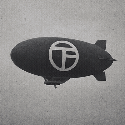 Black and White Blimp With T