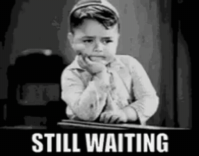 Black And White Boy Sitting At Desk Still Waiting GIF