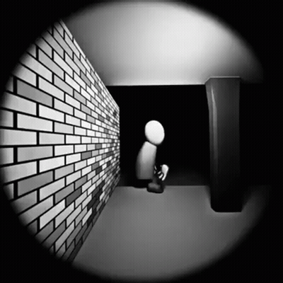 Black And White Brick Wall With Person Kneeling In Dark GIF