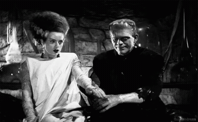 Black And White Bride And Groom Sitting Together GIF