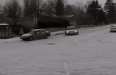 Black And White Car Driving Through Snow GIF