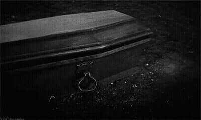 Black And White Coffin With Hand Sticking Out GIF