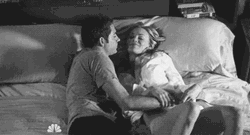 Black And White Couple On Bed Snuggles GIF