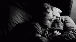 Black And White Couple Snuggles On Bed GIF