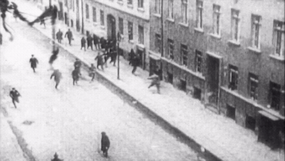 Black And White Crowd Running Down Street GIF