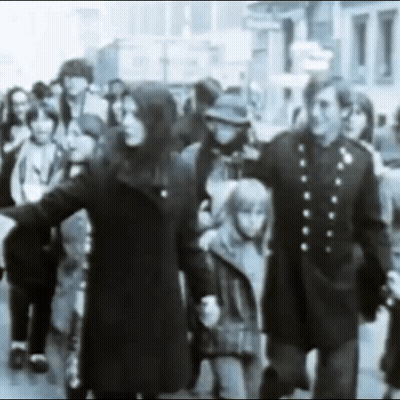 Black And White Crowd Walking Down Street GIF