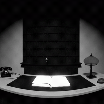 Black And White Desk With Open Book And Lamp GIF