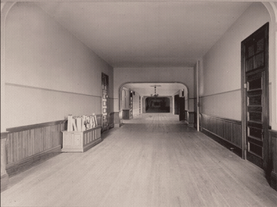 Black And White Hallway With Bookshelf Saying A GIF