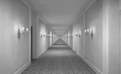 Black And White Hotel Hallway With Door GIF