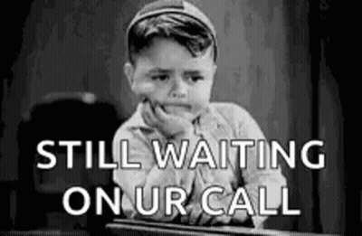 Black And White Little Boy Waiting For Call At Desk GIF