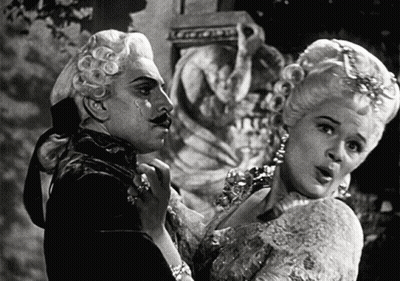 Black And White Man And Woman In Costumes GIF