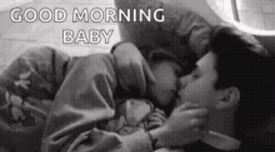 Black And White Man And Woman Kissing In Bed GIF