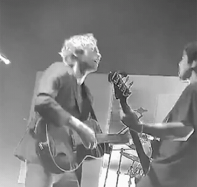 Black And White Man And Woman Playing Guitar And Bass GIF