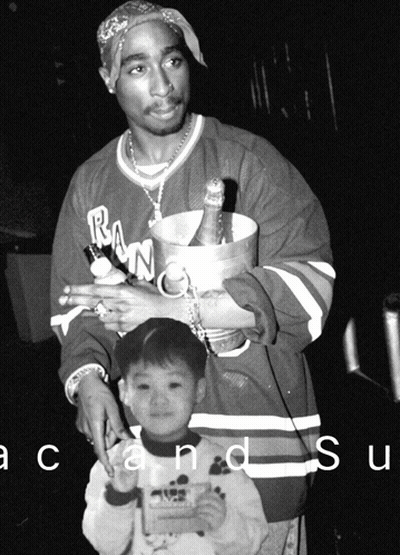 Black and White Man Holding Bucket of Champagne and Little Boy