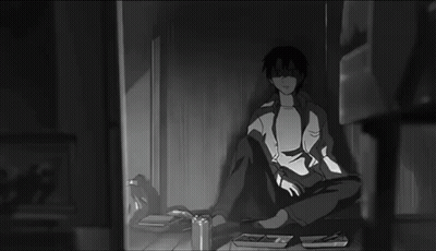 Black And White Man Holding Remote In Dark Room GIF